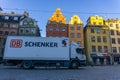 Square with famous colorful buildings and white delivery truck in front of them in the early morning