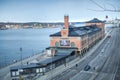 Stockholm, Sweden - 04.15.2017: Red brick building of Fotografiska, museum of photography, close to water canal in