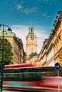 Stockholm, Sweden. Red Bus In Motion Blur Rides Near Old Town With Tower Of Storkyrkan - The Great Church Or Church Of Royalty Free Stock Photo