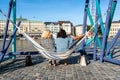 Stockholm, Sweden, 08.06.2021: Swing colorful hammocks are installed on waterfront of Stockholm in the old town. Nice view to