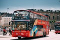 Stockholm, Sweden. Tourists People Ride In Red Hop On Hop Off Touristic Bus For Sightseeing Down The Street Near Royalty Free Stock Photo