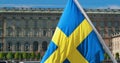 Stockholm, Sweden. Waving Swedish Flag In Stockholm Street. 4K Royalty Free Stock Photo