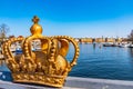 Stockholm viewed behind an ornamental golden crown on the Skeppsholmsbron bridge, Sweden