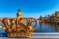 Stockholm viewed behind an ornamental golden crown on the Skeppsholmsbron bridge, Sweden