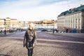 Stockholm in winter. Person walking in urban city street in Sweden. Happy tourist looking at buildings in the old town. Royalty Free Stock Photo