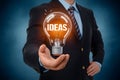 StockImage Businessman holds light bulb, indicating new ideas, 3D illustration