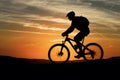 StockImage Silhouette of a mountain biker against sunset sky photo Royalty Free Stock Photo