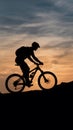 StockImage Silhouette of a mountain biker against sunset sky photo Royalty Free Stock Photo