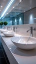 StockPhoto Modern public bathroom concept row of white ceramic washbasins