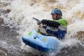 Man in a kayak with paddle in white water. Action shot