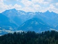 Stoderzinken - Majestic view of Dachstein mountain range framed by lush green alpine forests in Stoderzinken, Styria, Austria Royalty Free Stock Photo