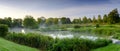 Misty dawn light on Stoke Charity village pond and St Michael`s Church, Hampshire, UK Royalty Free Stock Photo