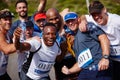 Stoked for this run. Portrait of a group of excited young men standing together after running a marathon.