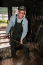 Stoker shoveling coal in a train furnace