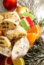 Stollen and jelly fruits on golden christmas plate