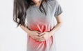 Stomach aches and Monthly period pain. Young woman holding stomach with red highlight Royalty Free Stock Photo