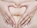 Stomach fat female body part to heart symbol. Royalty Free Stock Photo