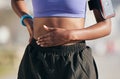 Stomach, sports woman and pain from exercise injury, problem and first aid for fitness. Closeup, female athlete and