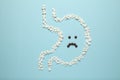 Stomach of tablets, sad face. Gastritis and digestive problems, ulcers Royalty Free Stock Photo