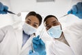 Stomatological Treatment. Black dentist and doctors assistant checking patients teeth, low angle Royalty Free Stock Photo