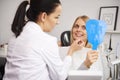 Stomatologist checking the woman`s teeth during dental checkup