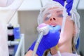 Stomatologist makes ultrasonic cleaning pours teeth with water, closeup view.