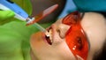 Stomatology light usage for teeth treatment modern equipment, process closeup