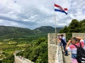 A group of tourists taking photos high up on the Walls of Ston