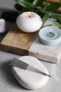 Stone with acupuncture needles on light grey marble table Royalty Free Stock Photo