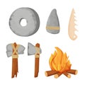 Stone age primitive tools, weapon set with bonfire, axe, wheel, sharpen rock and bone in cartoon style isolated on white Royalty Free Stock Photo