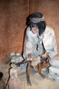 Stone age statue of a man working with molten metal in the Mondragon Palace museum, Ronda, Spain.