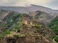 Stone ancient monastery on the green mountain. Memorial complex Vatan, Sogratl village in Dagestan. Russia Royalty Free Stock Photo