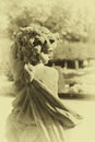 Stone angel statue in garden. Guardian angel statue in sunlight as a symbol of love in garden. Royalty Free Stock Photo