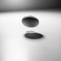 Stone appears to be levitating due to a thin, barely visible thread supporting Royalty Free Stock Photo