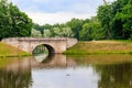 Stone arch bridge across lake in Gatchina, Russia Royalty Free Stock Photo