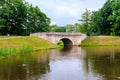 Stone arch bridge across a lake in Gatchina, Russia Royalty Free Stock Photo