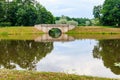 Stone arch bridge across a lake in Gatchina, Russia Royalty Free Stock Photo