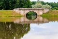 Stone arch bridge across lake in Gatchina, Russia Royalty Free Stock Photo