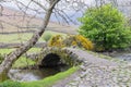 Stone arch bridge across a small stream in Lake District National Park