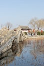 Stone arch bridge and Chinese pavilion at Daming Lake in Jinan, Shandong, China at dusk Royalty Free Stock Photo