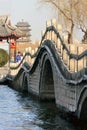 Stone arch bridge and Chinese pavilion at Daming Lake in Jinan, Shandong, China at dusk Royalty Free Stock Photo