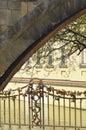 The stone arch of a bridge, with padlocks on the iron framework. Royalty Free Stock Photo