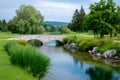Stone arch bridge spanning river in golf course landscape Royalty Free Stock Photo