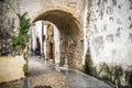 Old stone arch on the narrow street of Coimbra town in Portugal in the evening Royalty Free Stock Photo