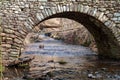 Stone Arch over a creek in winter Royalty Free Stock Photo