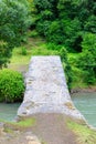 The stone arched bridge over the mountain river in Georgia Royalty Free Stock Photo