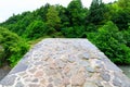 The stone arched bridge over the mountain river in Georgia Royalty Free Stock Photo