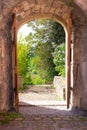 Stone arched entryway leads into landscape garden