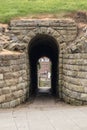 Stone arched passageway through historic wall with view on other. Royalty Free Stock Photo