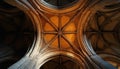 Stone arches create gothic ceiling pattern. Intricate design shows architecture. Vaulted design visible in dim lighting. Royalty Free Stock Photo